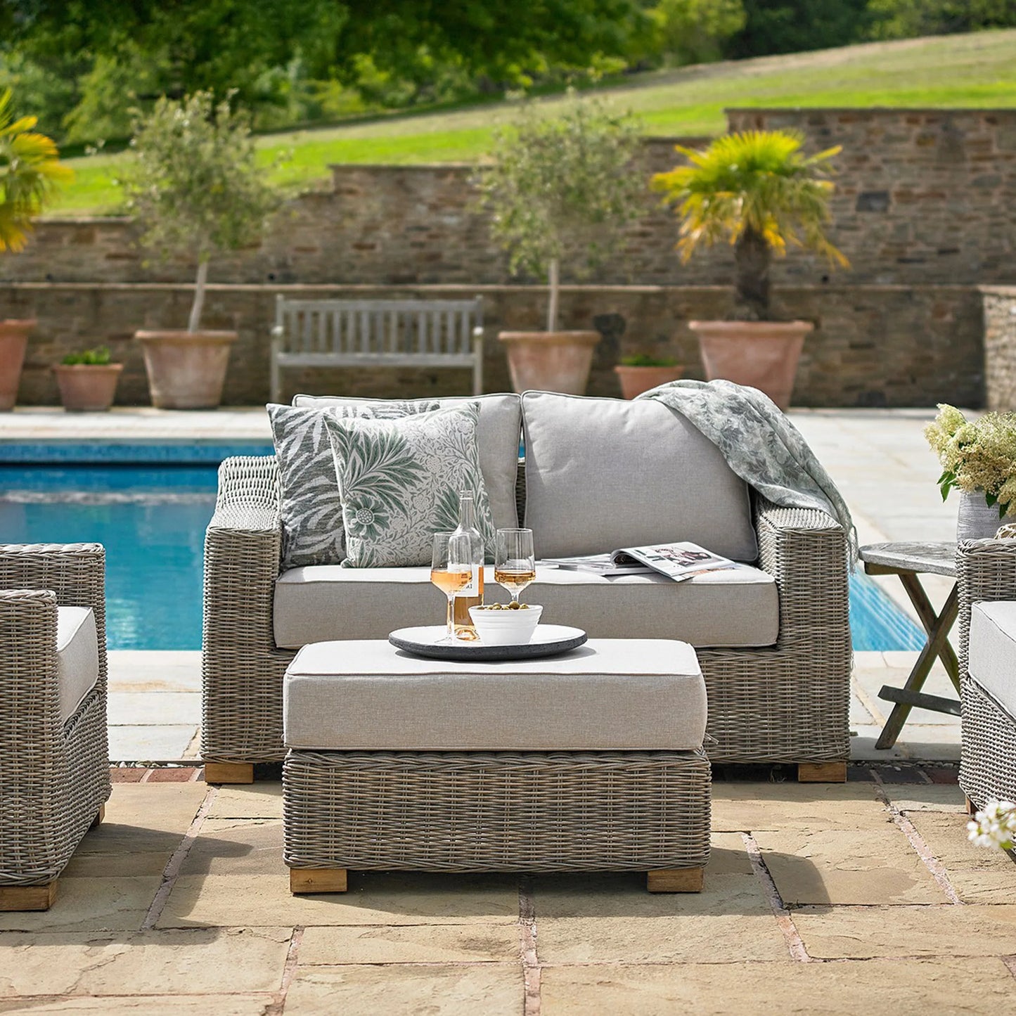 Luxury Capri Outdoor In Beige Wicker Footstool With Acacia Wood Feet And Weatherproof Cushion