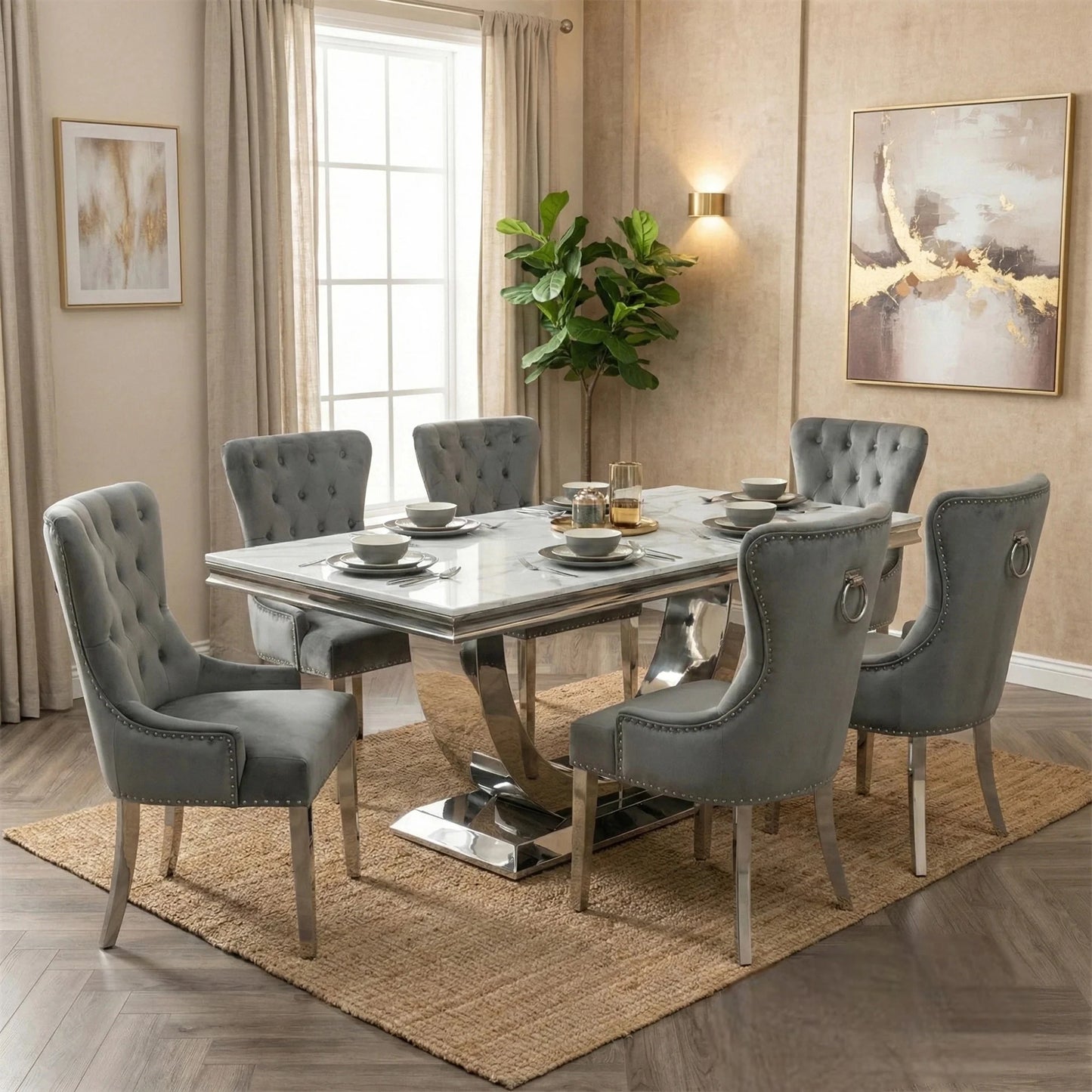 Dining room with a marble table and gray chairs, featuring a rug and wall art.